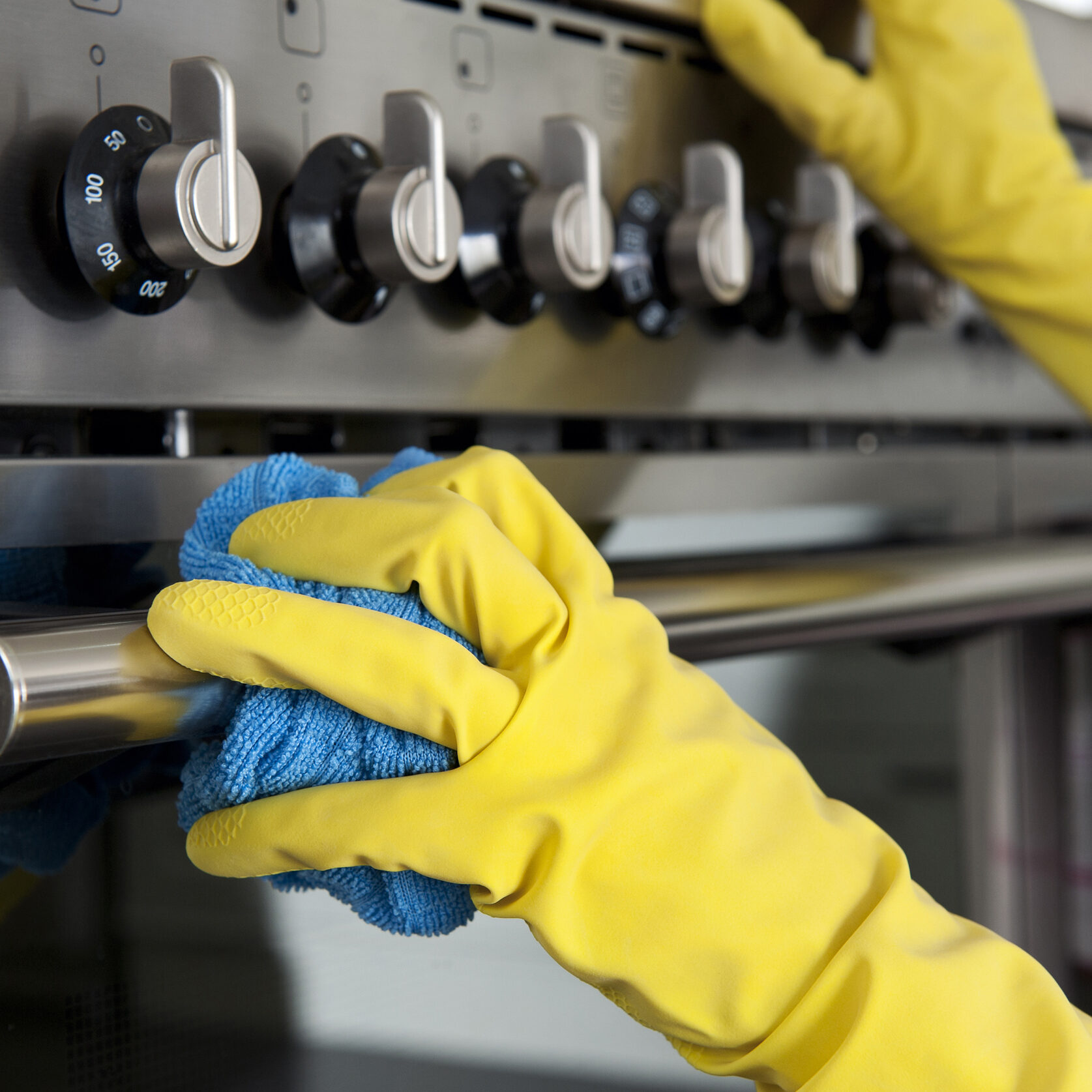 Close up of an oven being cleaned.